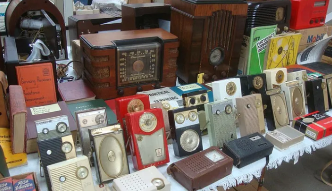 Collection of vintage radios displayed for sale, showcasing diverse designs and eras, perfect for eBay reselling.